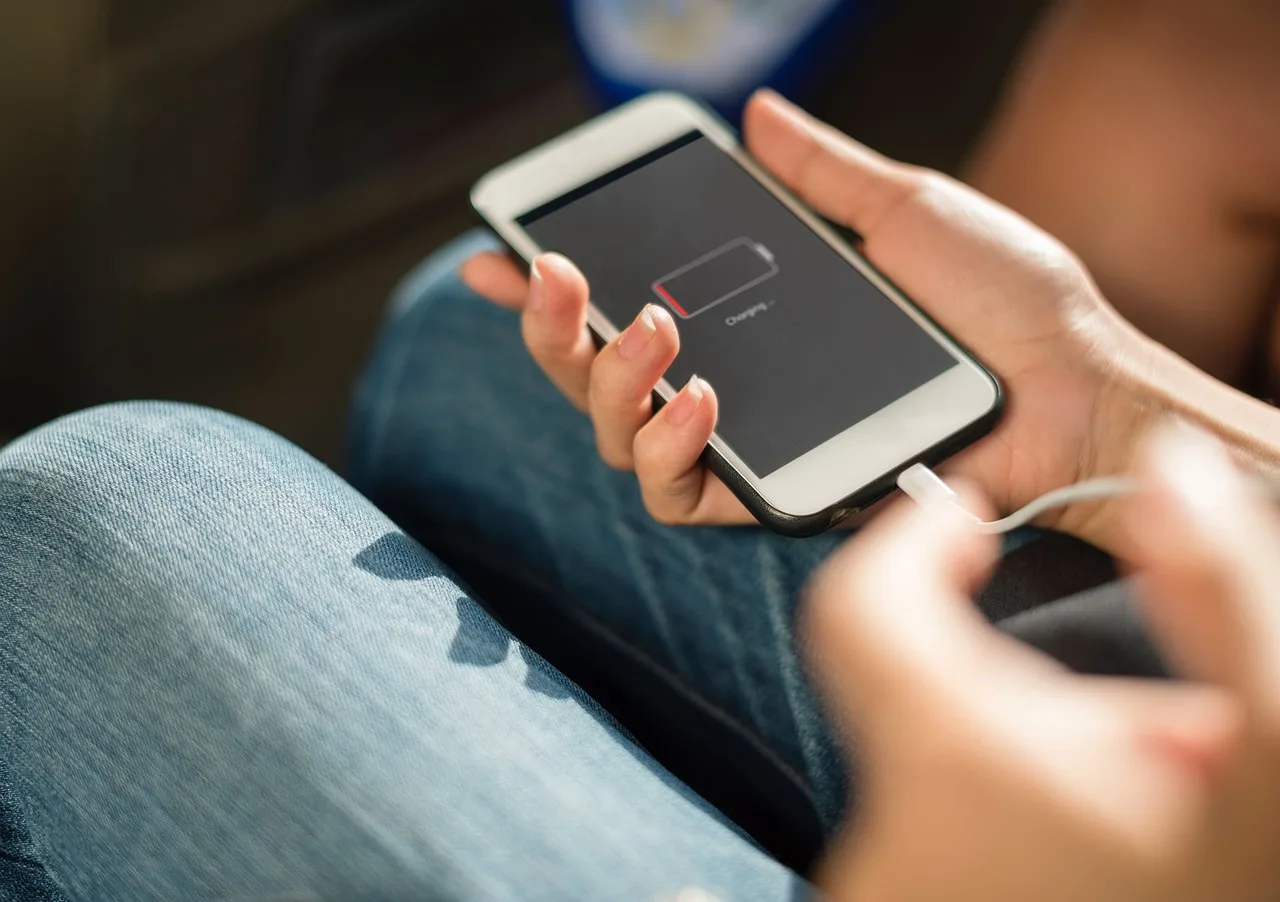 smartphone, mobile, phone, gadget, touchscreen, battery, charger, cord, hand, battery, battery, battery, battery, battery, charger, charger, charger, charger. How to Buy a Used Phone Without Getting Burned: IMEI, Battery, and iCloud Checks
