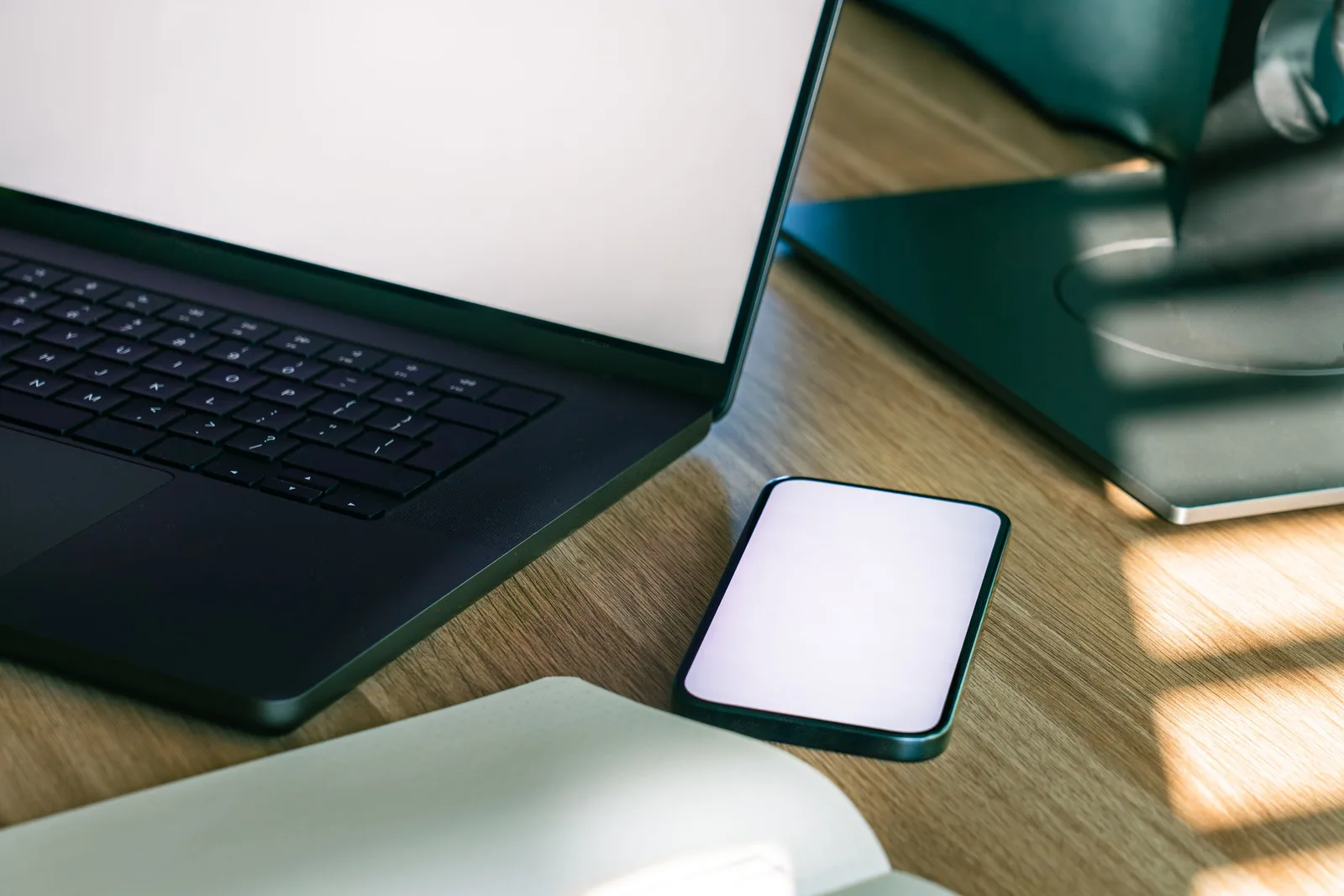 A sleek office desk setup featuring a laptop and smartphone, ideal for tech and business themes. Cloud storage basics: how sync, sharing, and recovery work