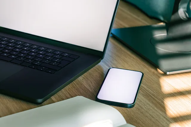 A sleek office desk setup featuring a laptop and smartphone, ideal for tech and business themes. Cloud storage basics: how sync, sharing, and recovery work