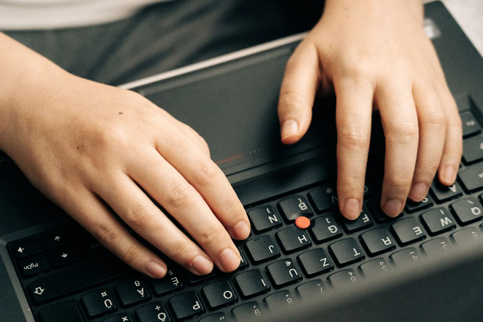 Close-up of hands typing on a black laptop's keyboard emphasizing productivity. 8 things nobody tells you about email takeover recovery case
