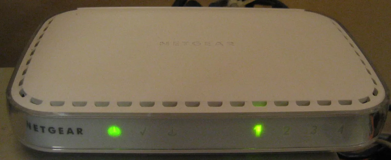 A white wireless router with status lights illuminated