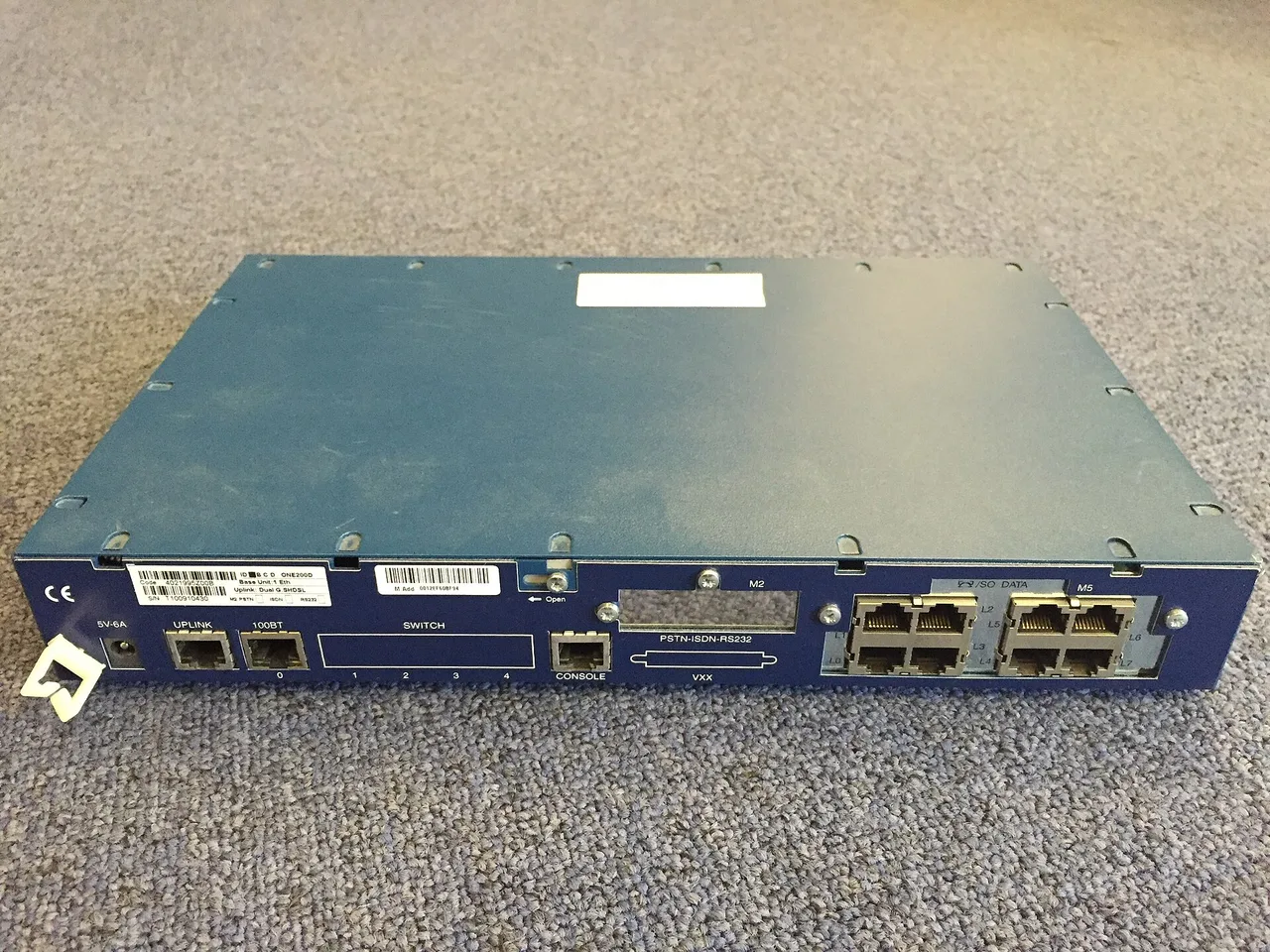 Back of a voice and network router with labeled power and data ports