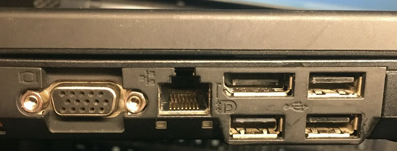 Close view of VGA, Ethernet, DisplayPort, and USB ports on an older laptop